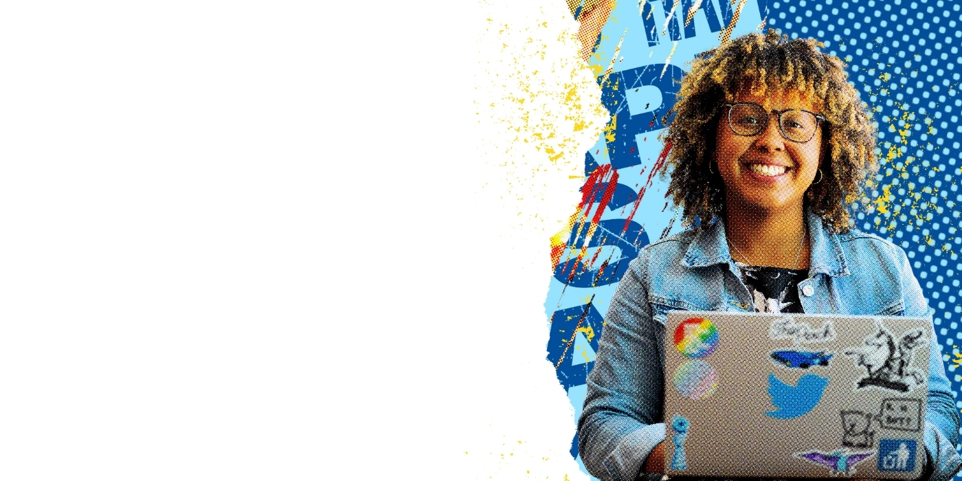 A Twitter employee sits behind a laptop, smiling.